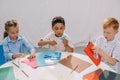 focused multiracial kids making paper applique