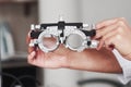 Focused photo. Female hands holding the optical device for eye testing Royalty Free Stock Photo