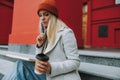 Pretty woman with coffee to go making homework Royalty Free Stock Photo