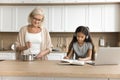 Focused pre teen schoolkid girl doing homework task at home Royalty Free Stock Photo