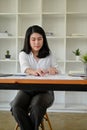 Focused Asian businesswoman working on the financial report spreadsheet at her desk Royalty Free Stock Photo