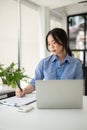 A focused and professional Asian businesswoman is working on her business work at her desk Royalty Free Stock Photo