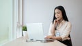 A focused and professional Asian businesswoman is working on her laptop computer in the office Royalty Free Stock Photo