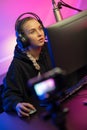 Focused Professional E-sport Gamer Girl with Headset Streaming Online Video Game on PC Royalty Free Stock Photo