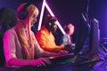 Focused Professional E-sport Gamer Girl with Headset Streaming Online Video Game on PC Royalty Free Stock Photo