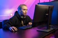 Focused Professional E-sport Gamer Girl in Hoody Playing Online Video Game on PC Royalty Free Stock Photo