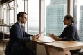 Serious hr manager holding job interview with indian applicant. Royalty Free Stock Photo