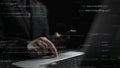 Focused programmer coding on laptop with smartphone in dark room featuring floating programming texts and binary data Royalty Free Stock Photo