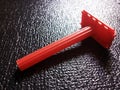 Focused Red Razor on Black Wrinkled Surface Royalty Free Stock Photo