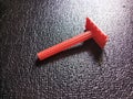 Focused Red Razor on Black Wrinkled Surface Royalty Free Stock Photo