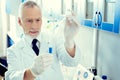 Focused researcher using pipette while working with chemical liquids