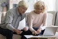 Focused retired married couple checking paper bills, invoices Royalty Free Stock Photo