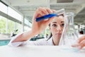 Focused science student pouring liquid Royalty Free Stock Photo