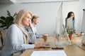 Focused senior businesswoman working on desktop sitting at offic