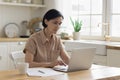 Focused senior freelance professional woman working from home