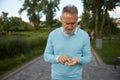 Focused senior man counting coins from his wallet Royalty Free Stock Photo