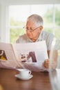 Focused senior man reading newspaper Royalty Free Stock Photo