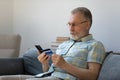 Focused senior older man using banking app, financial virtual service Royalty Free Stock Photo