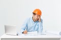 Focused serious hardworking engineer busy working on big architectural project late, sitting at his workspace using Royalty Free Stock Photo