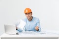 Focused serious hardworking engineer busy working on big architectural project late, sitting at his workspace using Royalty Free Stock Photo