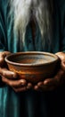 Focused shot empty bowl held by old mans hands, depicting hunger and poverty