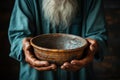 Focused shot empty bowl held by old mans hands, depicting hunger and poverty