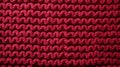 focused shot of red knitted texture background Royalty Free Stock Photo