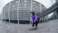 Focused skater riding on urban background. Sporty guy jumping on skate outdoor. Royalty Free Stock Photo