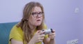 Focused sloppy woman plays game console refusing to distract