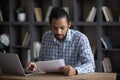 Focused smart 30s millennial African American businessman working with documents. Royalty Free Stock Photo