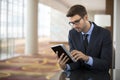 Focused Smart Young Businessman on Tablet