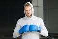 Focused sport goal achievement. Sportsman concentrated training boxing gloves. Athlete concentrated face sport gloves