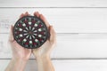 Focused Strategy: Hands Holding Dartboard Representing Precision and Targeted Goals Royalty Free Stock Photo