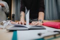 Person organizes papers at a collaboration center desk during a focused study session Royalty Free Stock Photo