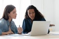 Focused successful mixed race female entrepreneurs discussing project. Royalty Free Stock Photo