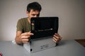 Focused technician examining components of disassembled laser printer, troubleshooting and performing maintenance in Royalty Free Stock Photo