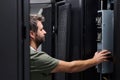 It technician servicing a server rack in a data center performing hardware maintenance and inspection Royalty Free Stock Photo