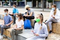 Focused teen students in masks during lesson outside