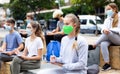 Focused teen students in masks during lesson outside