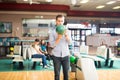 Focused Teenage Boy Preparing To Throw Bowling Ball Royalty Free Stock Photo