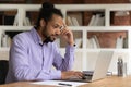 Focused thoughtful African American businessman looking at laptop screen Royalty Free Stock Photo