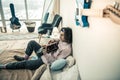 Focused unusual young man resting in bedroom with guitar