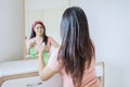 Focused view of beautiful woman cleaning a dresser