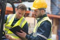 Focused warehouse workers talking together Royalty Free Stock Photo