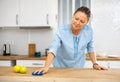 Focused woman cleaning kitchen table at home Royalty Free Stock Photo