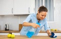 Focused woman cleaning kitchen table at home Royalty Free Stock Photo