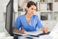 Focused woman doctor working with laptop in office Royalty Free Stock Photo