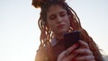 Focused woman reading message on cellphone. Serious girl typing on phone screen. Royalty Free Stock Photo