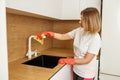 Woman Disinfecting Kitchen Sink with Spray Royalty Free Stock Photo