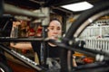 Focused woman repairing bicycle in workshop Royalty Free Stock Photo
